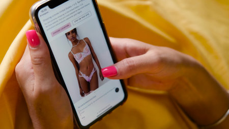 Buying underwear. Closeup shopping young woman chooses underwear in online store. Online shopping concept. Russia, Novosibirsk, August 17, 2022のeditorial素材