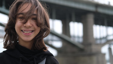 Portrait of a young girl who smiles happily with braces on her teeth. Portrait of a teenager on a...