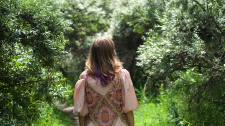 A young woman is enjoying the beautiful weather on a summer day.の写真素材