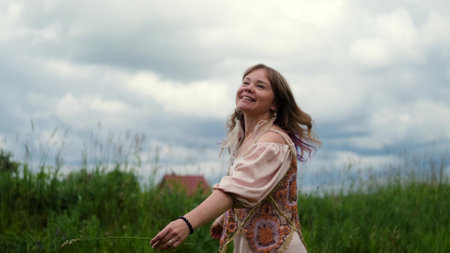 A young woman is enjoying the beautiful weather on a summer day.の写真素材