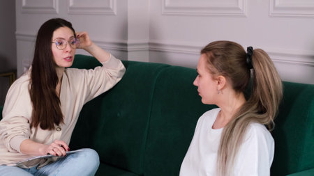 A woman psychotherapist conducts a reception in her office. The patient expresses her feelings in a one-on-one relationship with a specialist. Mental health conceptの写真素材