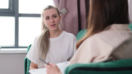 A woman psychotherapist conducts a reception in her office. The patient expresses her feelings in a...