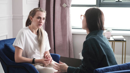 A woman psychotherapist conducts a reception in her office. The patient expresses her feelings in a one-on-one relationship with a specialist. Mental health conceptの写真素材