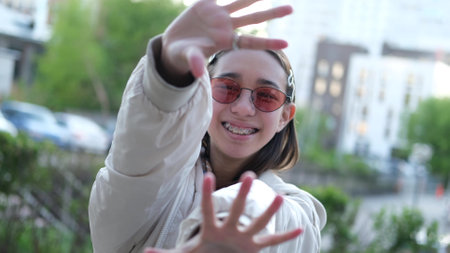 Teenage girl smiling at camera in summer outdoorsの写真素材