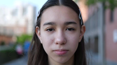 Portrait of a beautiful sad teenage girl outdoors close-upの写真素材