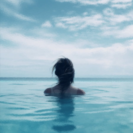 Rear view of woman in swimming pool while relaxing at resortの写真素材