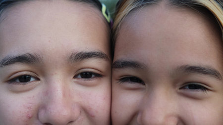 Close-up of the eyes of two teenage sisters. Friendship, family and healthcare concept