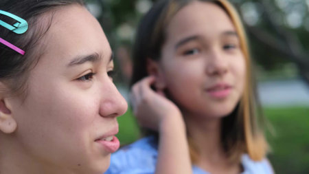 Two teenage sisters smile, have fun and communicate with each other. Friendship, family and healthcare conceptの写真素材