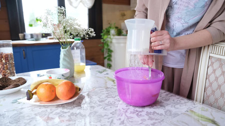 Happy attractive young woman, housewife, baker, cooking, preparing breakfast for family, preparing...