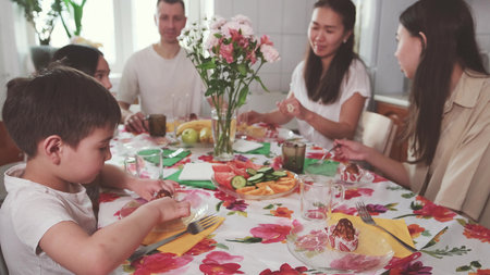 A family sits at the table early in the morning and enjoys breakfast together