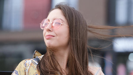 Happy woman in pink sunglasses outdoors smilingの写真素材