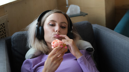 A girl in a homemade purple suit spends time alone at home. The girl listens to music on headphones,...