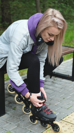 Cute blonde puts on roller skates. She feels free and light while roller skating alone in the city...