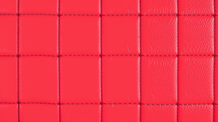The surface texture of artificial leather in red, stitched in the form of rhombuses, squares, rectangles. Quilted eco-leather.の素材