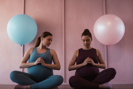 A group of pregnant women in tracksuits are doing gymnastics in a special roomの素材
