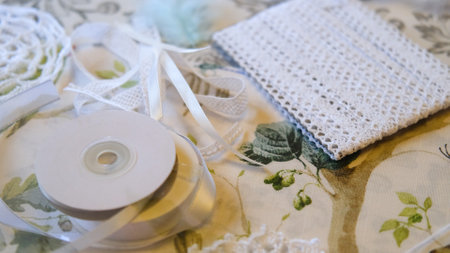Woman making dreamcatcher from threads, feathers, beads and silk ribbons, making home decor items, handmade amuletの写真素材