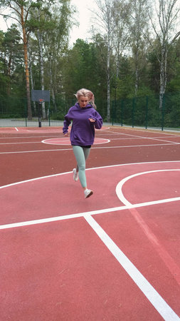 Running girl preparing for competition, race or marathon. Motivation, training for health and...
