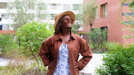 Young woman resting and relaxing while walking on city street in new eco-friendly residential complex. Relaxation and stress-free concept.の写真素材