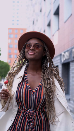 Young woman resting and relaxing while walking on city street in new eco-friendly residential complex. Relaxation and stress-free concept.の写真素材