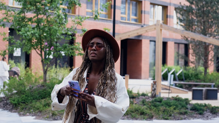 A woman uses a city map and geolocation on her smartphone to navigate the area while traveling.