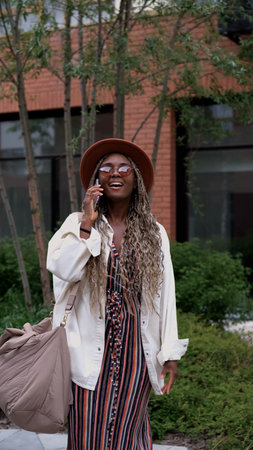 Happy attractive young woman smiling, laughing and talking on smartphone.