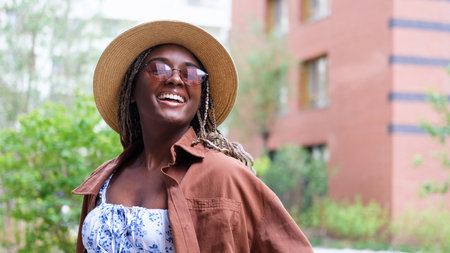 Young woman resting and relaxing while walking on city street in new eco-friendly residential complex. Relaxation and stress-free concept.の写真素材