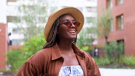 Young woman resting and relaxing while walking on city street in new eco-friendly residential complex. Relaxation and stress-free concept.の写真素材