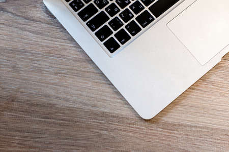 laptop keyboard on a wooden tableの写真素材