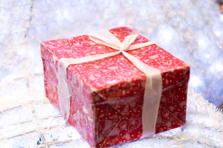 box with red ribbon and bow on white backgroundの写真素材