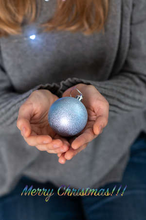 woman's hand holding christmas decorationの写真素材