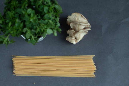 Pasta, basil, mushrooms, ingredients on gray backgroundの写真素材