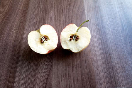 red apple on wooden table