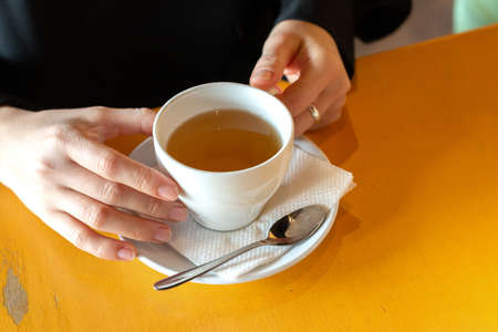 Woman is holding a herbal tea
