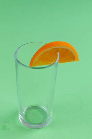 Empty glass with an orange sliceの写真素材