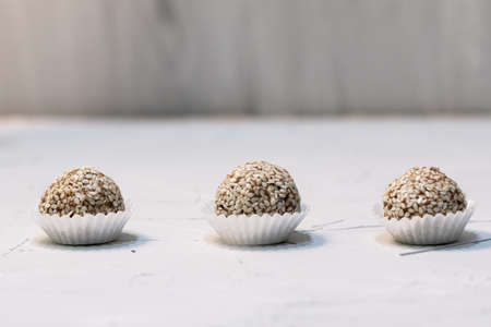 Homemade sweets energy balls made from superfoods like seeds, nuts and dried fruits. Healthy snack, raw dessert and superfood. With space for textの写真素材