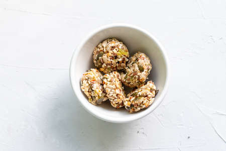 Homemade sweets energy balls made from superfoods like seeds, nuts and dried fruits. Healthy snack,...