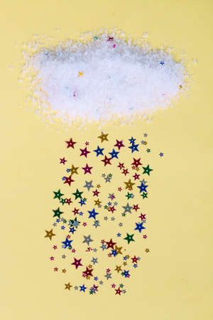 The cloud with rain from colored shiny stars, postcard template design with yellow background and...