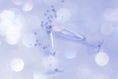 Vine glasses with a shiny snowflakes, Christmas card template, blue color tone, selective focusの写真素材