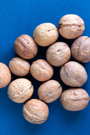 group of fresh wallnuts is on a blue background, healthy food concept