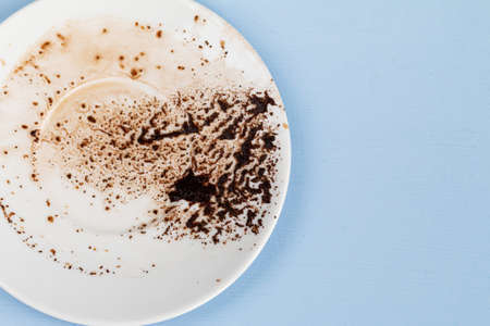 coffee grounds in a white cup ready for fortune telling, destiny reading concept, blue backgroundの写真素材