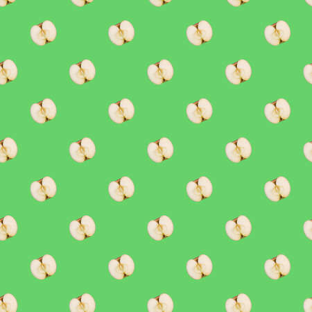 seamless pattern of half of delicious fresh apple against light green background, wrapping paper templateの写真素材