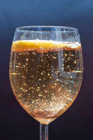 Sparkle lemonade in a glass, dark blue backgroundの写真素材