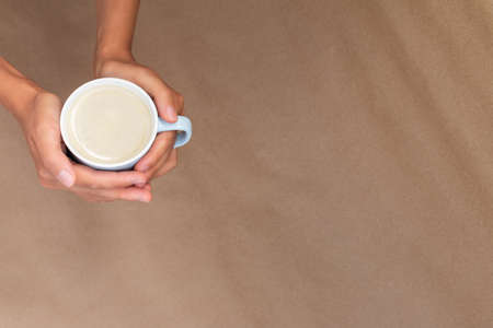 a cup of homemade hot milky coffee with empty space for text. Vivid bright colors