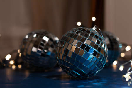 low key photo of disco ball with Christmas lights bokeh, greeting card wallpaper template with empty...