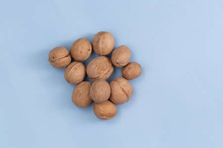 Group of walnuts on blue background