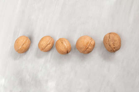 Group of walnuts on a concrete background
