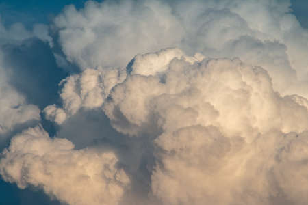 fluffy stormy clouds in the sunset skyの写真素材