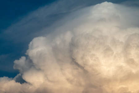 fluffy stormy clouds in the sunset skyの写真素材