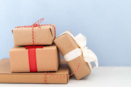 handmade gift box from paper craft with ribbon isolated on blue backgroundの写真素材