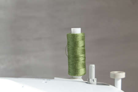 cotton Thread in green color against gray background, slow fashion and home sewing conceptの写真素材